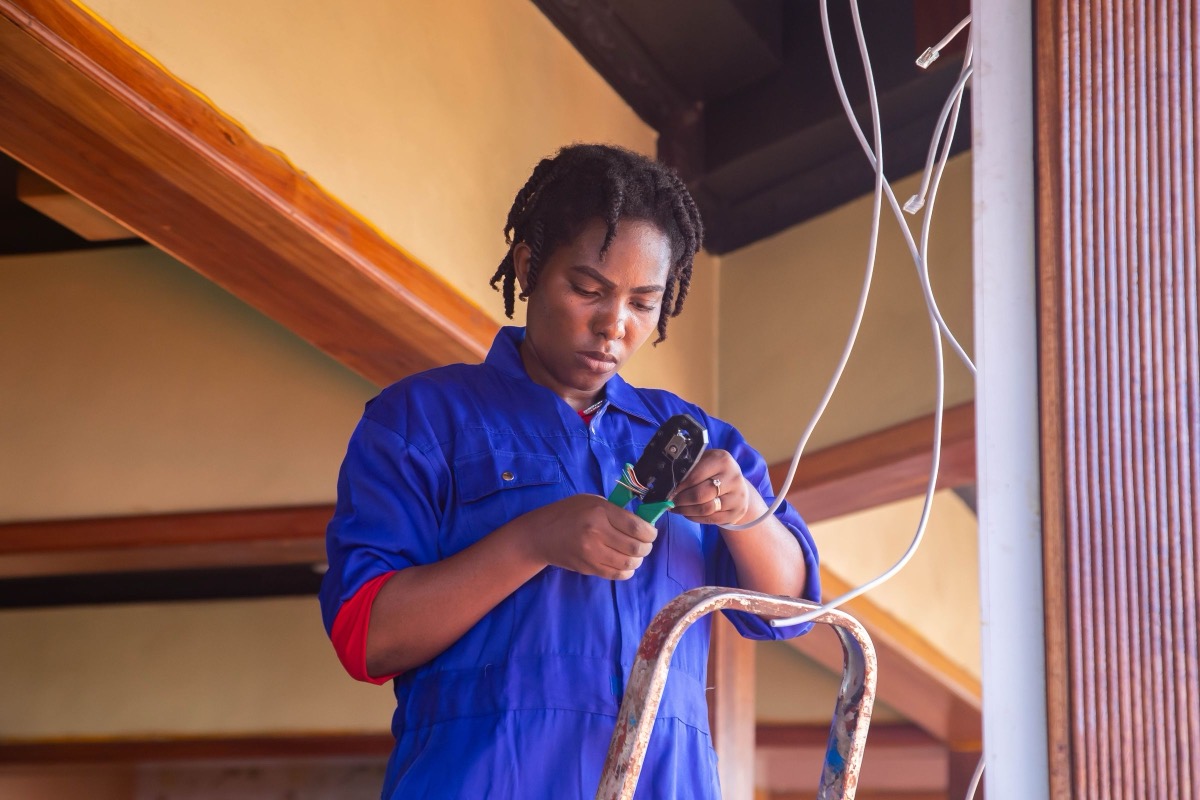 An electrician working on wiring in a home