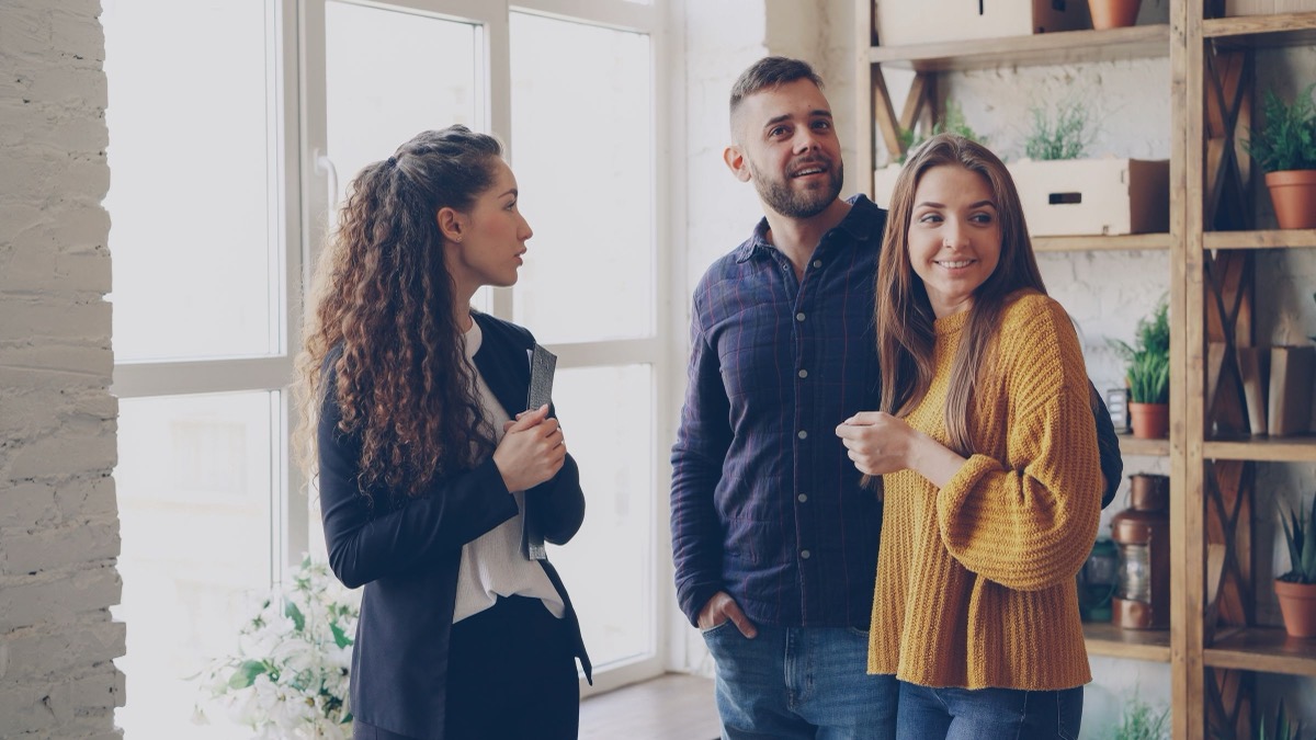 An estate agent showing an apartment to a couple